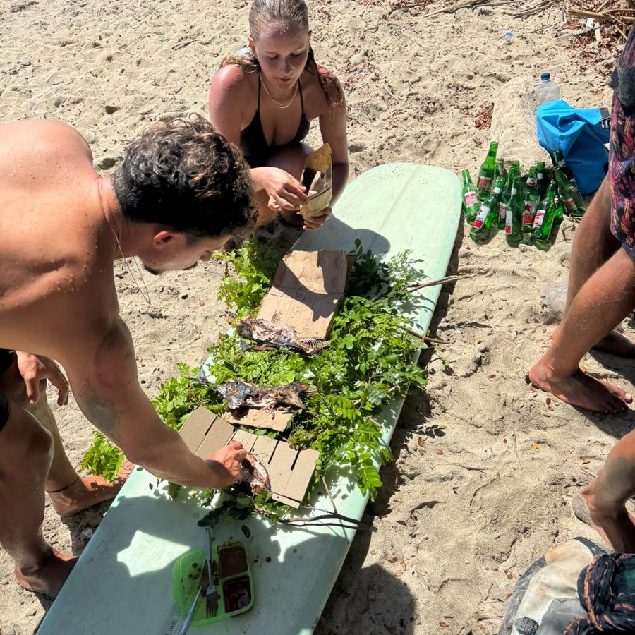 Lunch laid out on a surfboard on the sand