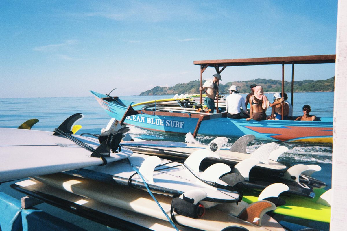 The boat loaded with boards, moored off the beach