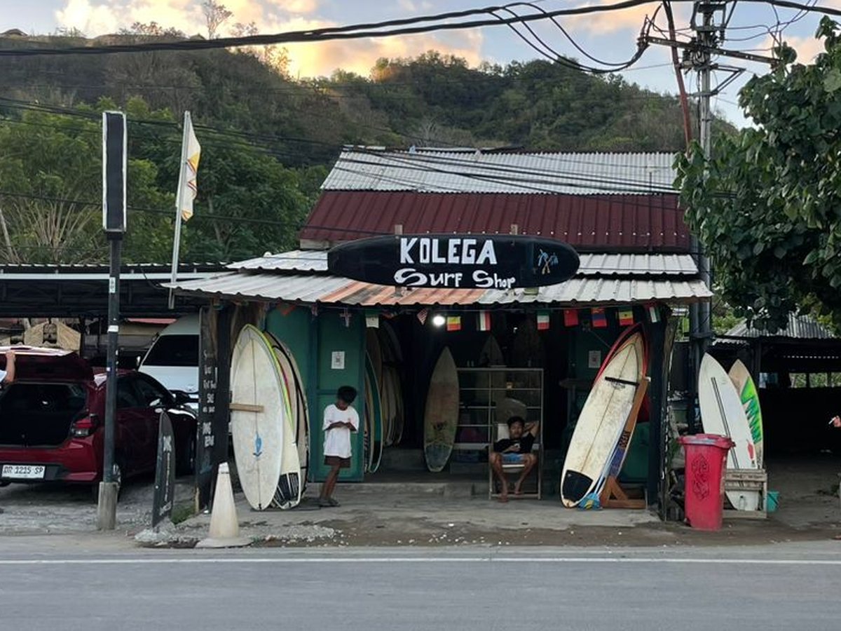Boards standing under the Kolega sign at the front of the shop